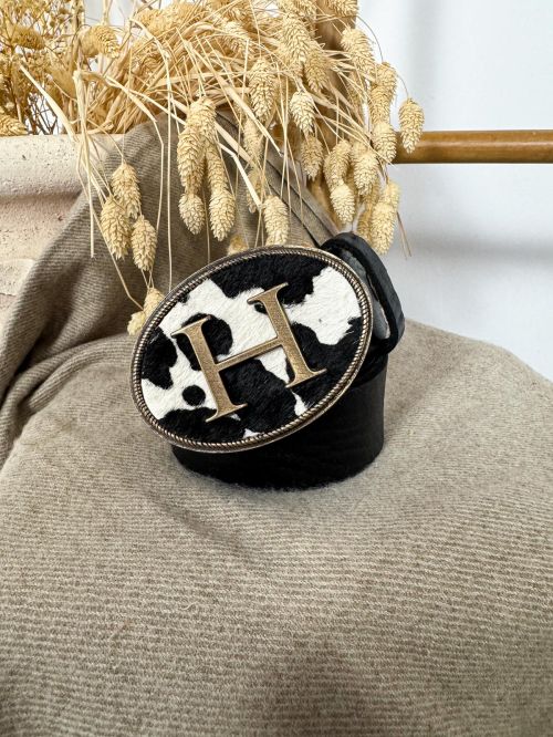 Hebilla ovalada pelo vaca inicial relieve H