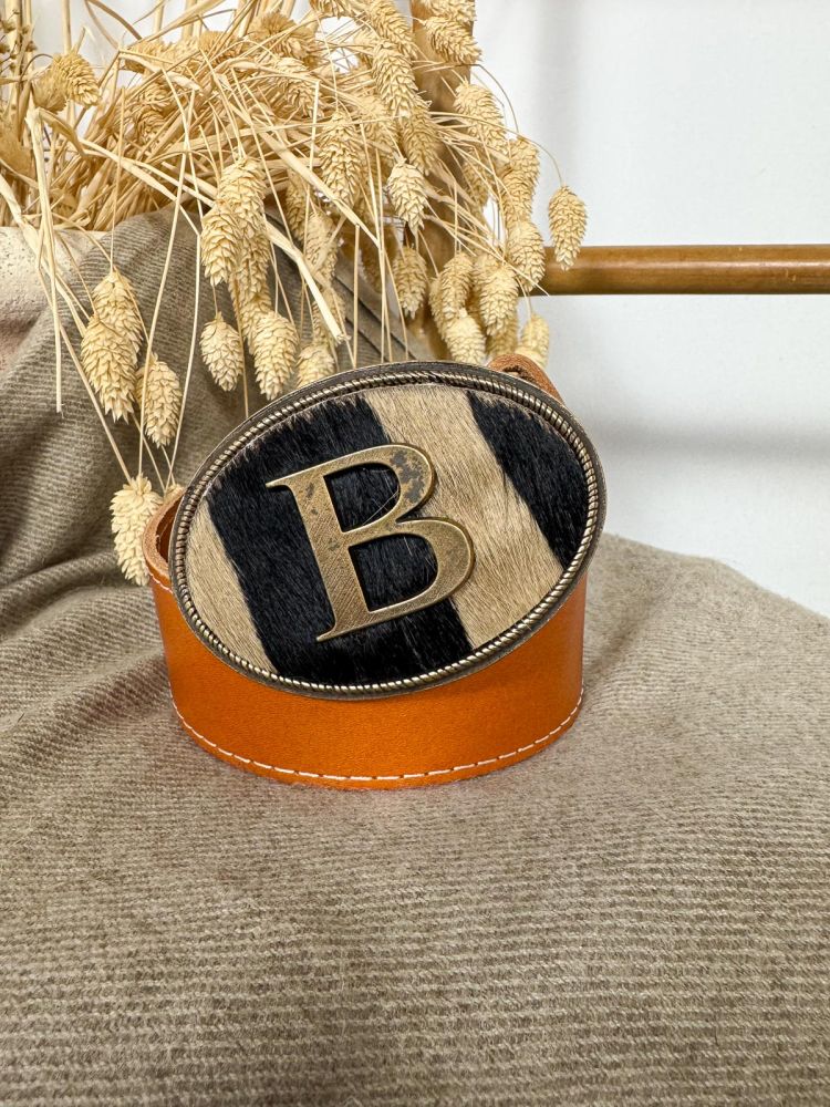 Hebilla ovalada pelo marrón y negro...