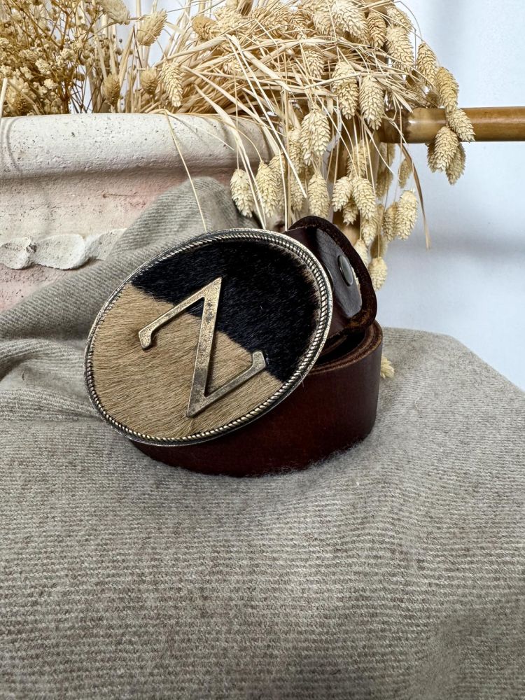 Hebilla ovalada pelo marrón y negro...